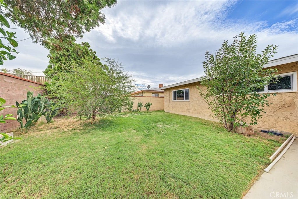44650 2nd Street E, Lancaster, CA 93535 Backyard is landscaped and has mature trees, block walls as well.
