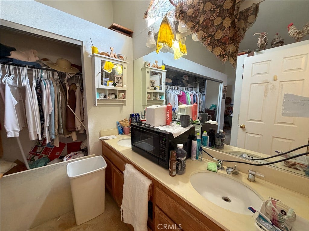 Bedroom with no closet doors. Double sink