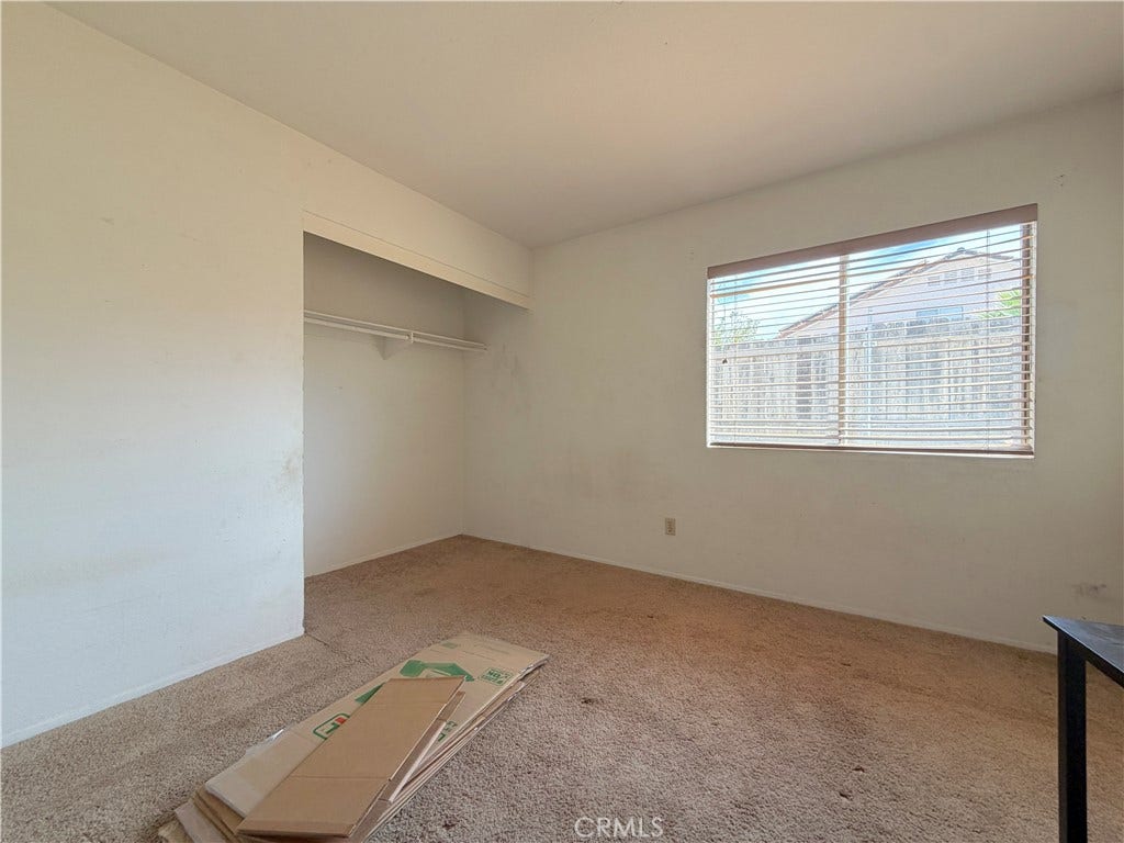 Bedroom with no closet doors