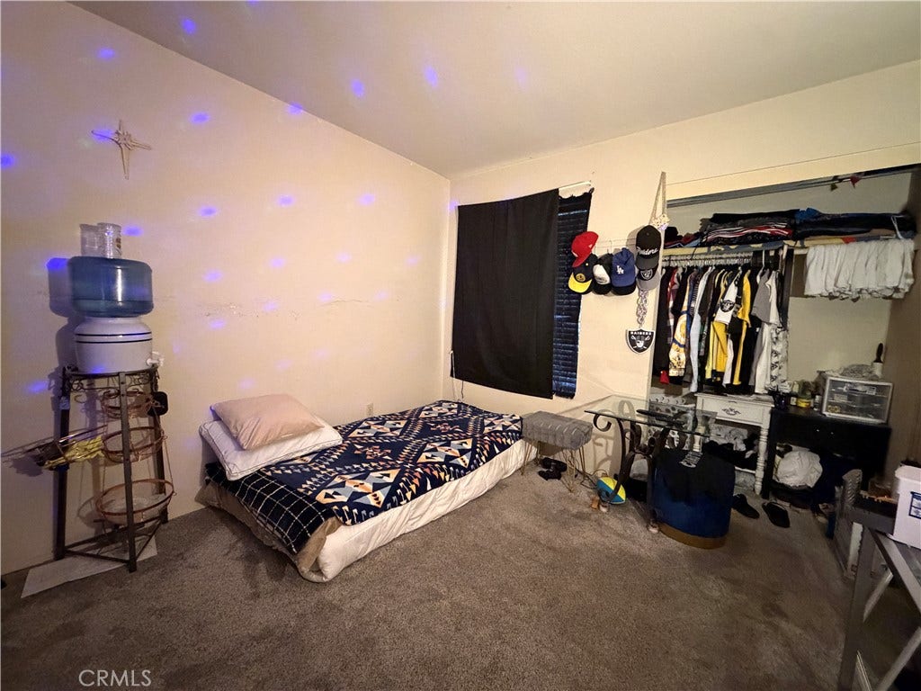 Bedroom with no closet doors