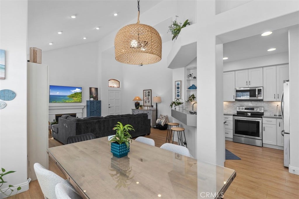 21121 Cancun, Mission Viejo, CA 92692 Luxurious Open Living Room & dining area W/ Fireplace. Plantation Shutters