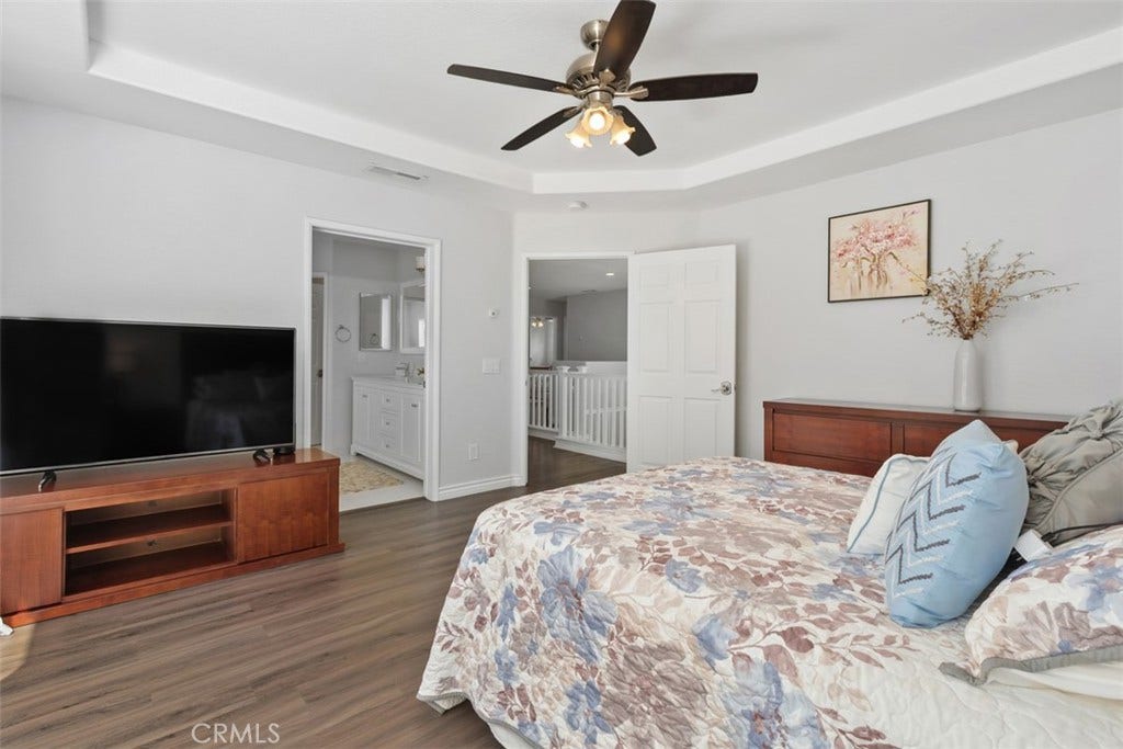 All bedrooms have ceiling fanlight fixtures. The primary bedroom offers the added elegance of a tray ceiling