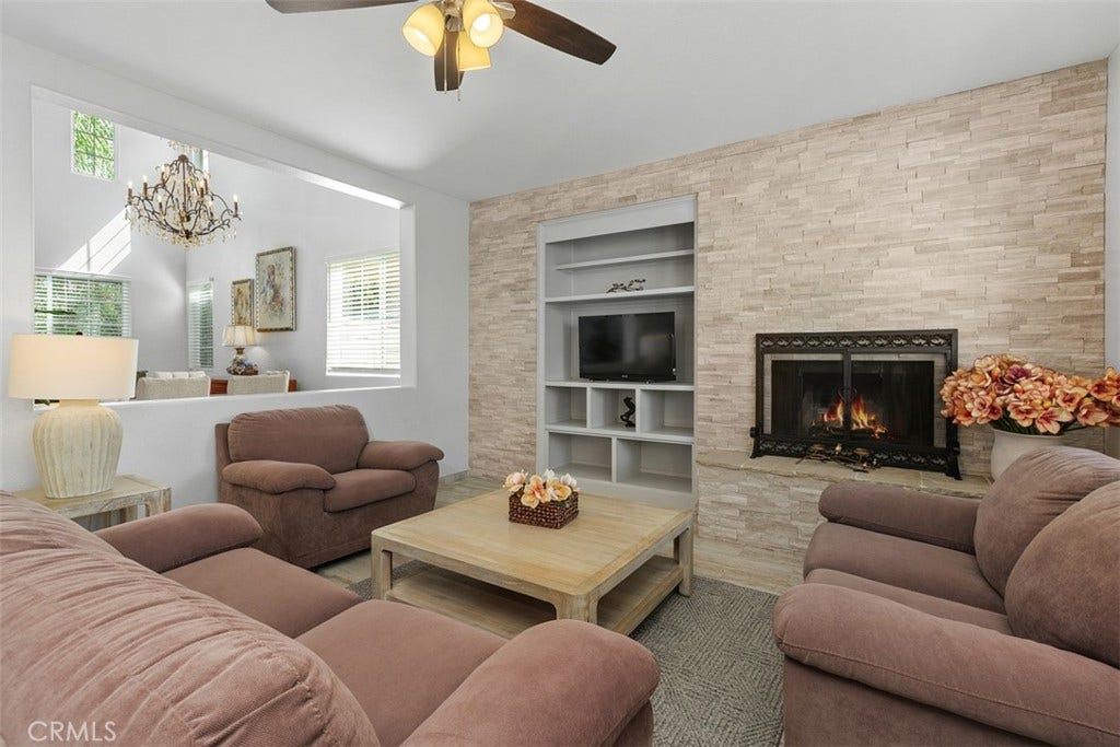 Virtual fire in stunning stone hearth and wall-to-wall surround w/a freshly-painted built-in entertainment center