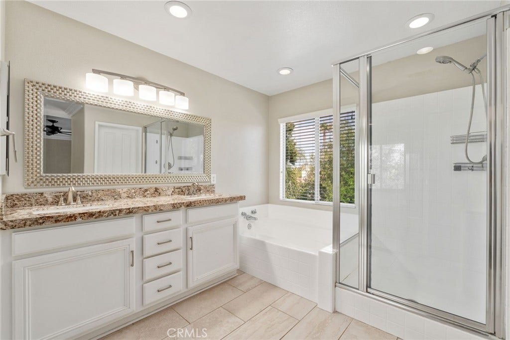 32440 Magenta Court, Temecula, CA 92592 Another View Of The Primary Bathroom Showcasing The Beautiful Vanity, Soaking Tub Beneath A Large Window, Separate Glass-Enclosed Shower, And Abundant Natural Light.