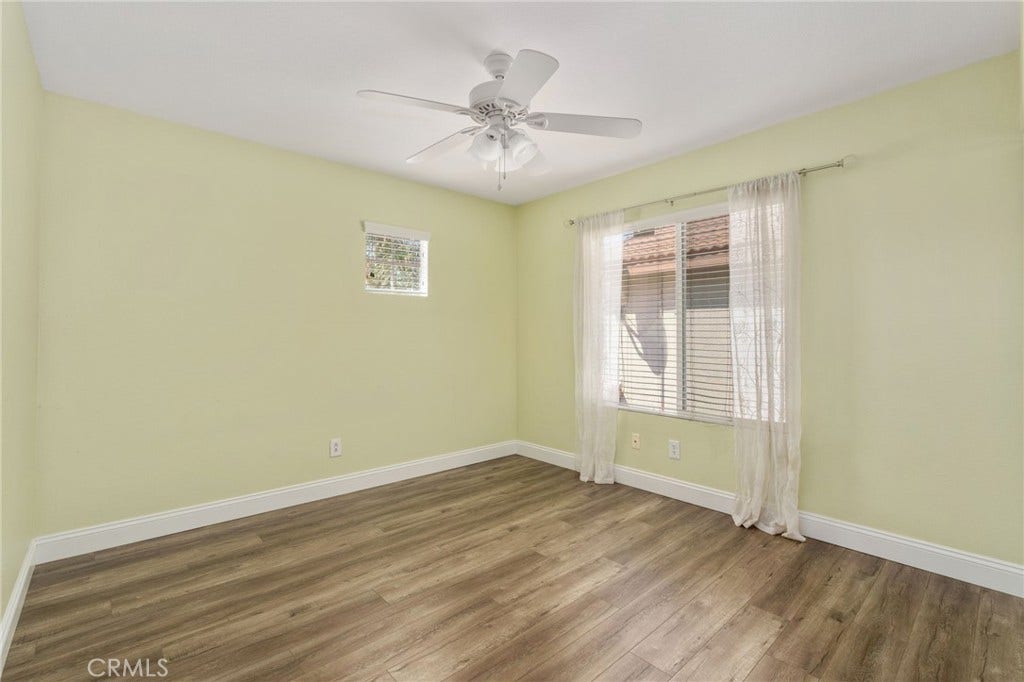 32440 Magenta Court, Temecula, CA 92592 Bright And Inviting Bedroom Featuring Wood-Look Flooring, A Ceiling Fan, Soft Wall Colors, And A Large Window Allowing Plenty Of Natural Light.