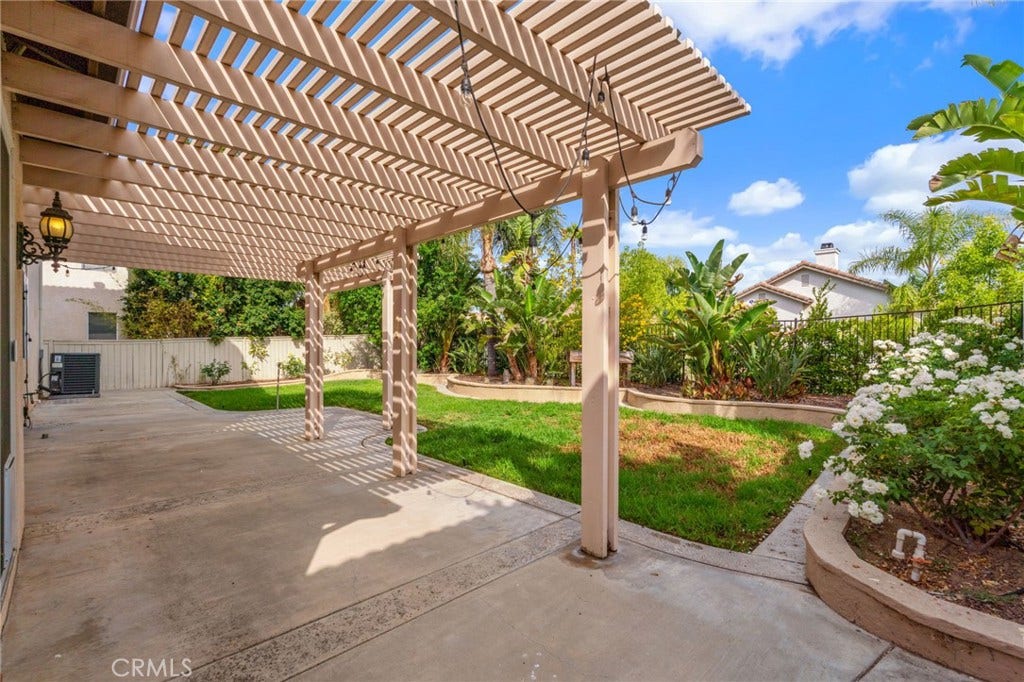 32440 Magenta Court, Temecula, CA 92592 Inviting Backyard Patio Featuring A Spacious Pergola, Comfortable Outdoor Seating Areas, And Beautiful Tropical Landscaping, Perfect For Relaxing Or Entertaining.