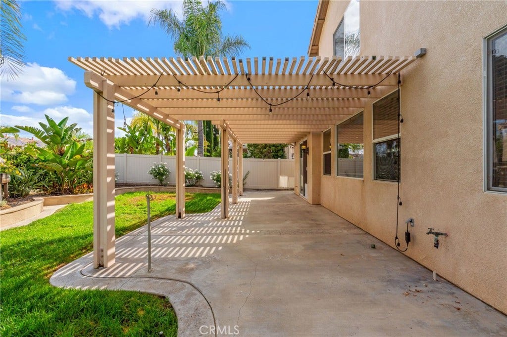 32440 Magenta Court, Temecula, CA 92592 Spacious Pergola-Covered Patio Featuring An Inviting Outdoor Dining Area, Comfortable Seating, And Views Of The Beautifully Landscaped Backyard.