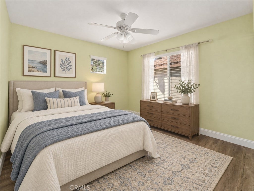32440 Magenta Court, Temecula, CA 92592 Bright And Inviting Bedroom Featuring Wood-Look Flooring, A Ceiling Fan, Soft Wall Colors, And A Large Window Allowing Plenty Of Natural Light. Digitally Staged