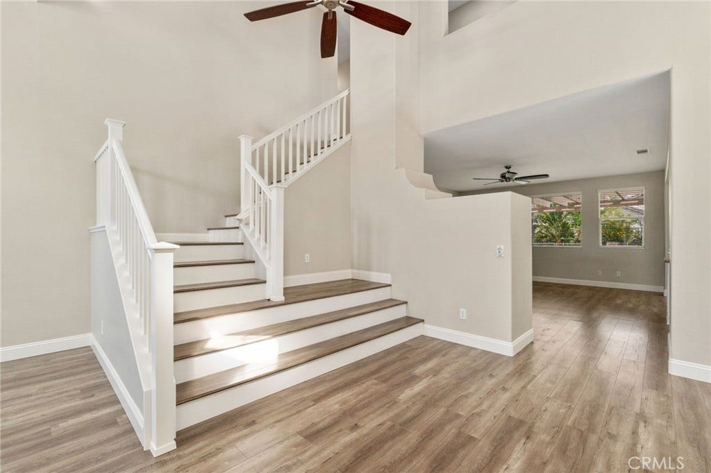 32440 Magenta Court, Temecula, CA 92592 Beautiful Staircase Featuring White Railings, Wood-Look Flooring, And An Open View Toward The Spacious Family Room.