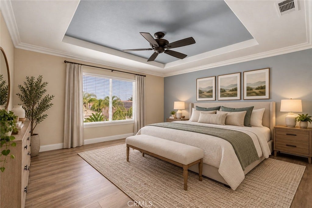 32440 Magenta Court, Temecula, CA 92592 Beautiful Primary Suite Featuring A Decorative Tray Ceiling With Crown Molding, Ceiling Fan, Attractive Wood-Look Flooring, And A Large Window Providing Abundant Natural Light. Digitally Staged