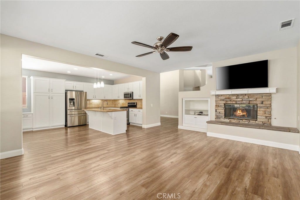 32440 Magenta Court, Temecula, CA 92592 Beautiful Open-Concept Family Room Featuring A Stone-Surround Fireplace, Built-In Shelving, And A Seamless Connection To The Spacious Kitchen And Dining Area.