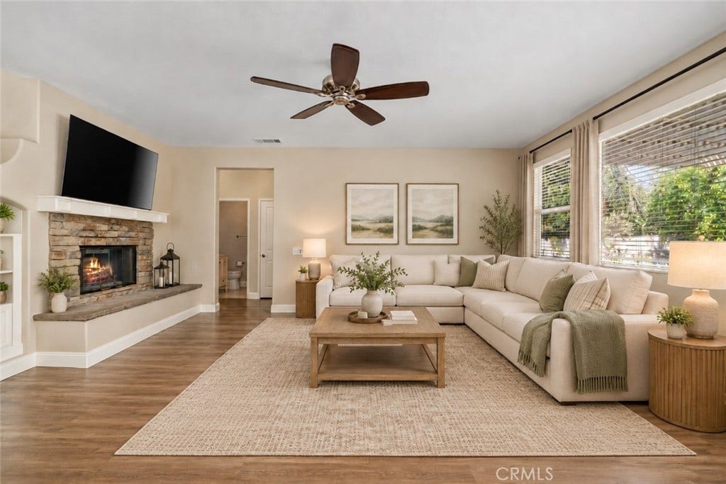 32440 Magenta Court, Temecula, CA 92592 Another View Of The Spacious Family Room Highlighting The Beautiful Stone-Surround Fireplace, Wood-Look Flooring, Ceiling Fan, And Abundant Natural Light. Digitally Staged