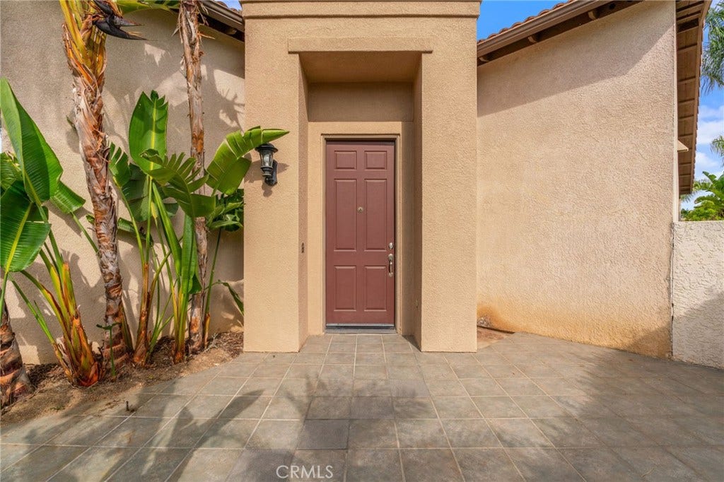 32440 Magenta Court, Temecula, CA 92592 Welcoming Front Entry Featuring A Recessed Front Door, Spacious Paved Courtyard, And Beautiful Tropical Landscaping.