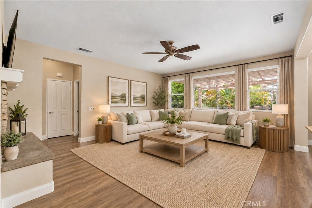 32440 Magenta Court, Temecula, CA 92592 Inviting Family Room Featuring Wood-Look Flooring, A Ceiling Fan, And Large Windows Overlooking The Backyard, Creating A Comfortable Space For Relaxation And Entertaining. Digitally Staged