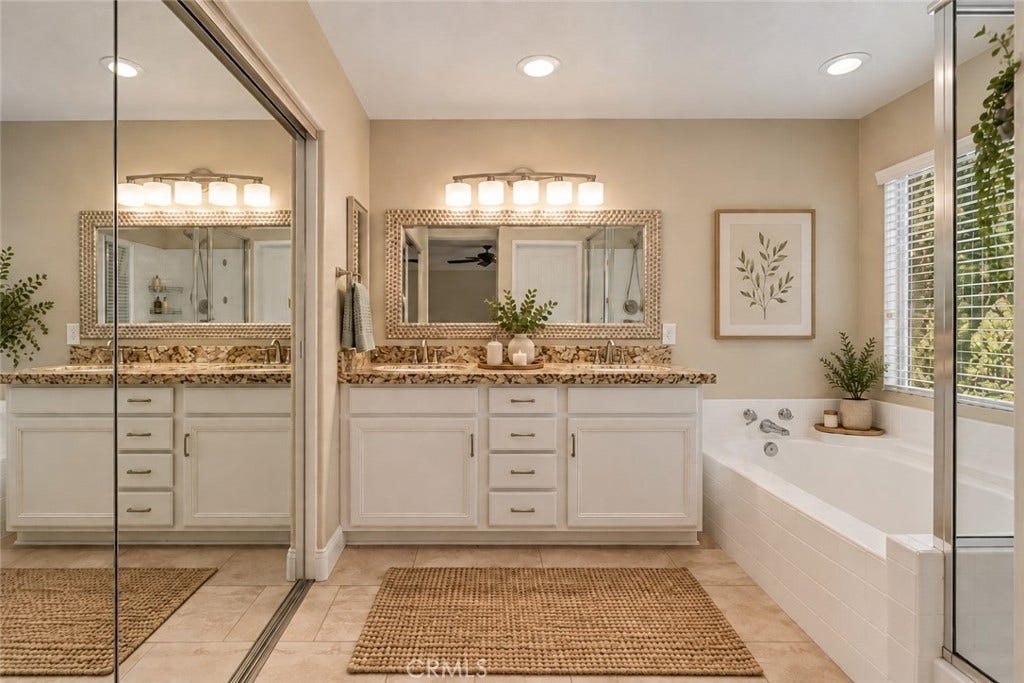32440 Magenta Court, Temecula, CA 92592 Spacious Primary Bathroom Featuring An Expansive Vanity With Generous Counter Space, Framed Mirror, Relaxing Soaking Tub, And Separate Glass-Enclosed Shower. Digitally Staged