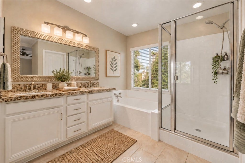 32440 Magenta Court, Temecula, CA 92592 Another View Of The Primary Bathroom Showcasing The Beautiful Vanity, Soaking Tub Beneath A Large Window, Separate Glass-Enclosed Shower, And Abundant Natural Light. Digitally Staged