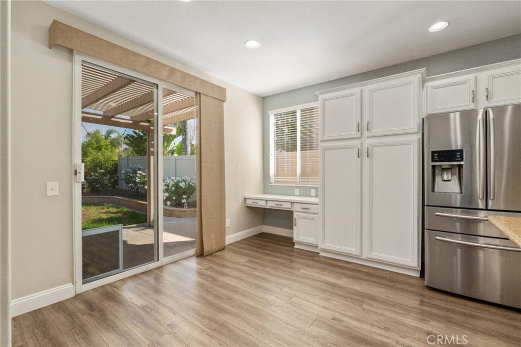 32440 Magenta Court, Temecula, CA 92592 Charming Dining Area Featuring Wood-Look Flooring, Abundant Natural Light, Sliding Glass Door Access To The Backyard, And A Convenient Built-In Desk Area.
