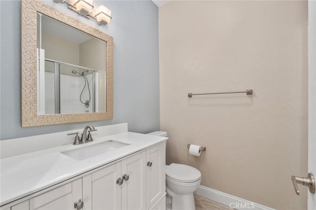 32440 Magenta Court, Temecula, CA 92592 Well-Appointed Bathroom Featuring A White Vanity, Framed Mirror, Tub And Shower Combination, And Attractive Accent Wall.