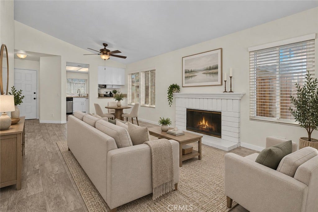 42329 Via Consuelo, Temecula, CA 92592 Another inviting view of the living room showcases the fireplace, natural light, and easy connection to the dining area and kitchen. Digitally Staged