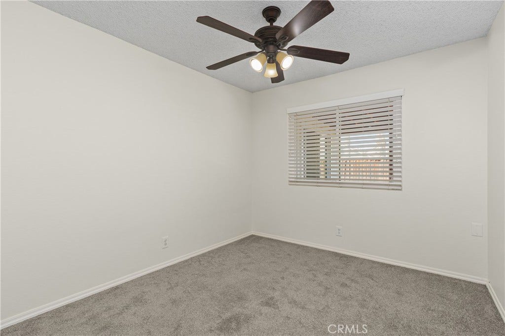 42329 Via Consuelo, Temecula, CA 92592 Secondary bedroom offering soft carpeting, a ceiling fan, and a window bringing natural light into the space.