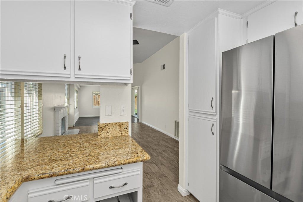 42329 Via Consuelo, Temecula, CA 92592 A view from the kitchen toward the living area showcases the home's open layout and convenient connection between the main gathering spaces.