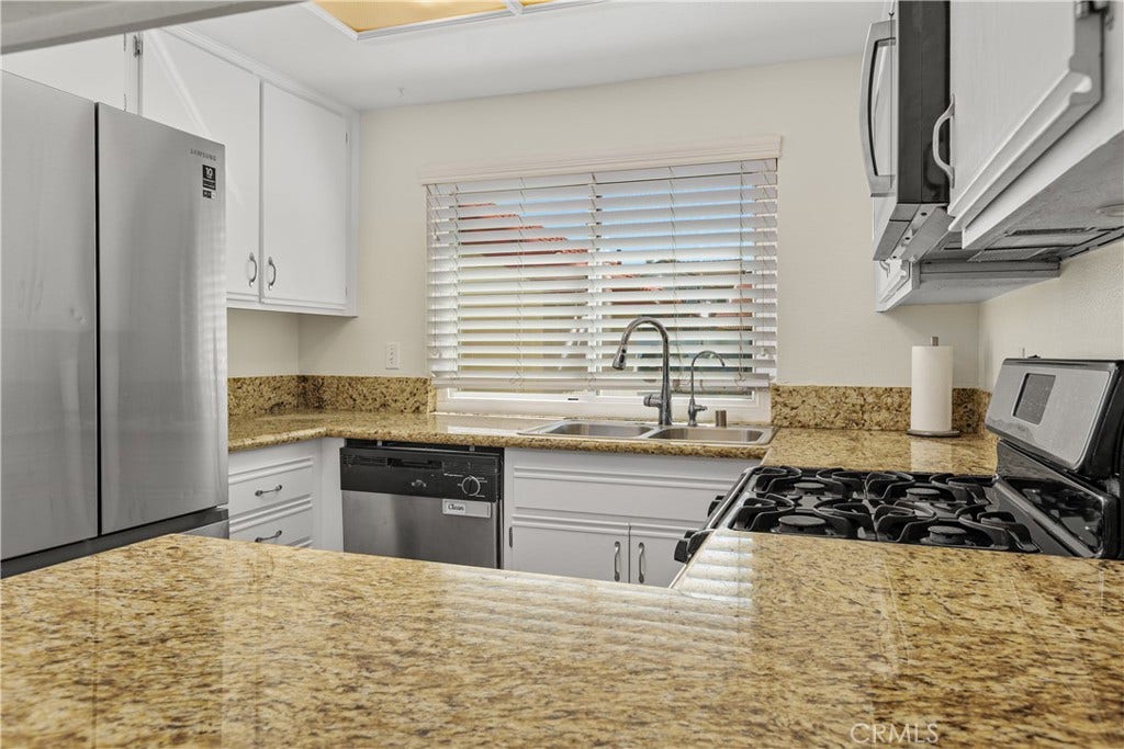 42329 Via Consuelo, Temecula, CA 92592 Another kitchen view highlights the granite countertops, double-basin sink beneath the window, and convenient countertop workspace.