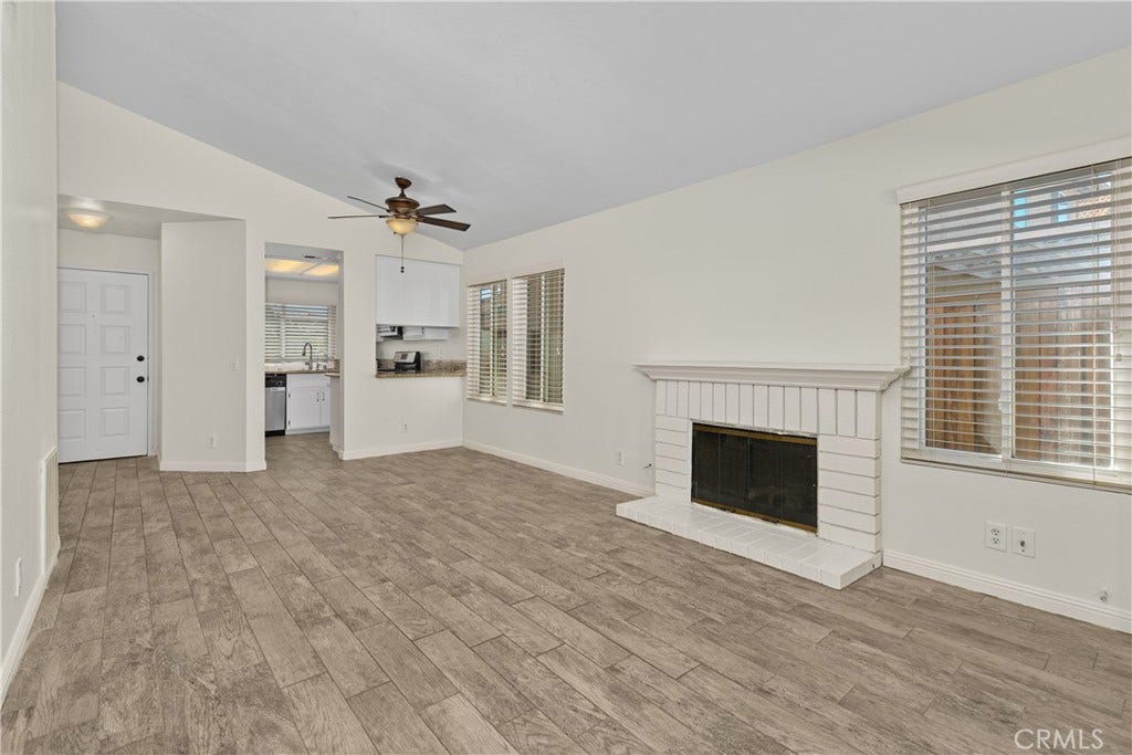 42329 Via Consuelo, Temecula, CA 92592 Another inviting view of the living room showcases the fireplace, natural light, and easy connection to the dining area and kitchen.