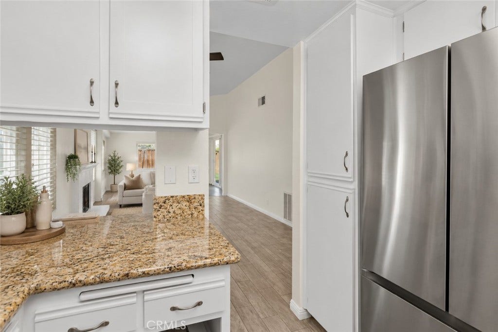 42329 Via Consuelo, Temecula, CA 92592 A view from the kitchen toward the living area showcases the home's open layout and convenient connection between the main gathering spaces. Digitally Staged