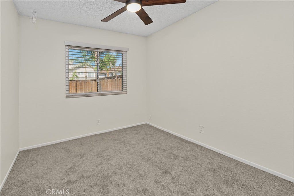 42329 Via Consuelo, Temecula, CA 92592 Another comfortable secondary bedroom featuring carpeted flooring, a ceiling fan, and natural light, with flexibility for guests, hobbies, or a home office.