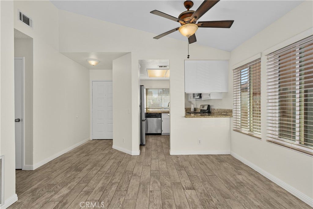 42329 Via Consuelo, Temecula, CA 92592 Dining area conveniently situated beside the kitchen, featuring a ceiling fan, large windows, and an open connection to the living space.