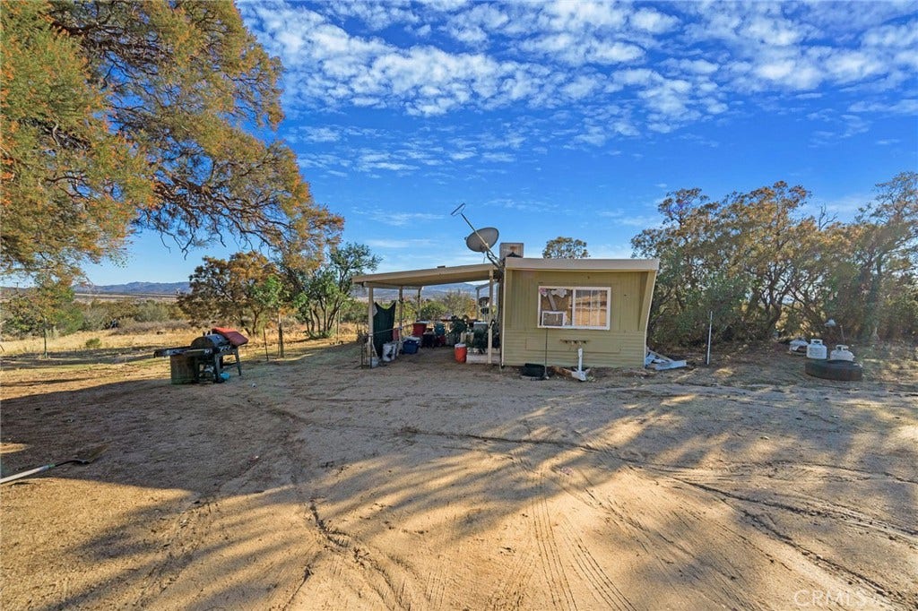 small trailer in back part of the property. Has its own entrance.
