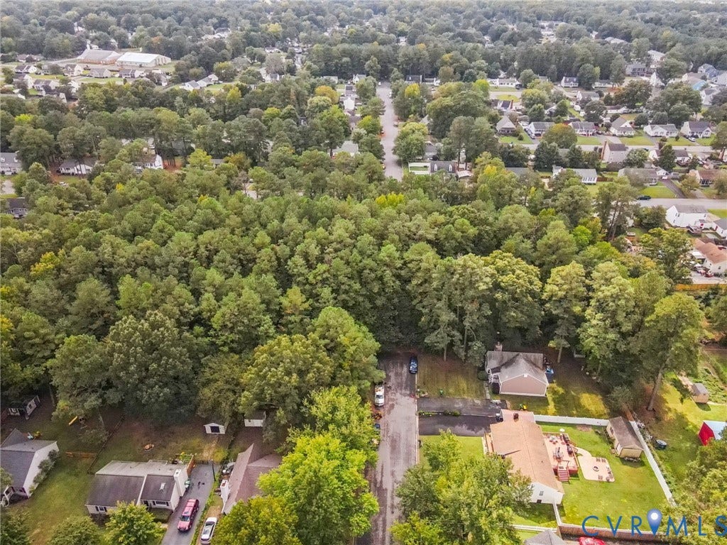 Aerial view of residential area featuring a forest
