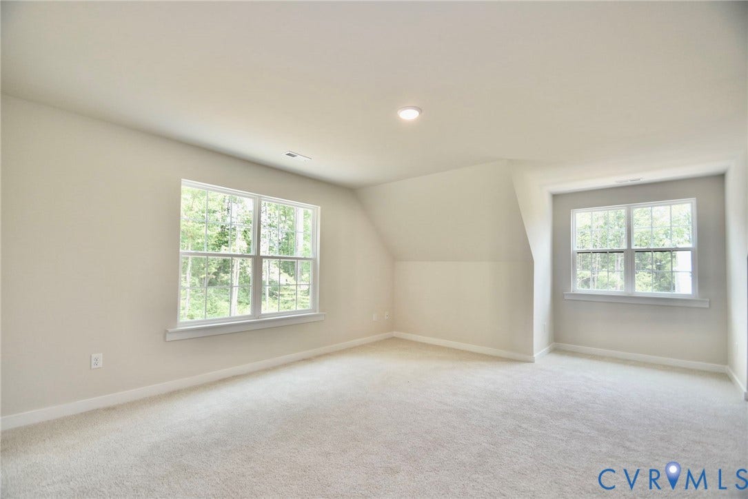 53 Porkchop Court, Louisa, VA 23093 Recessed ceiling lighting, sloped ceiling detail, two large windows, light-colored carpeting, and painted walls