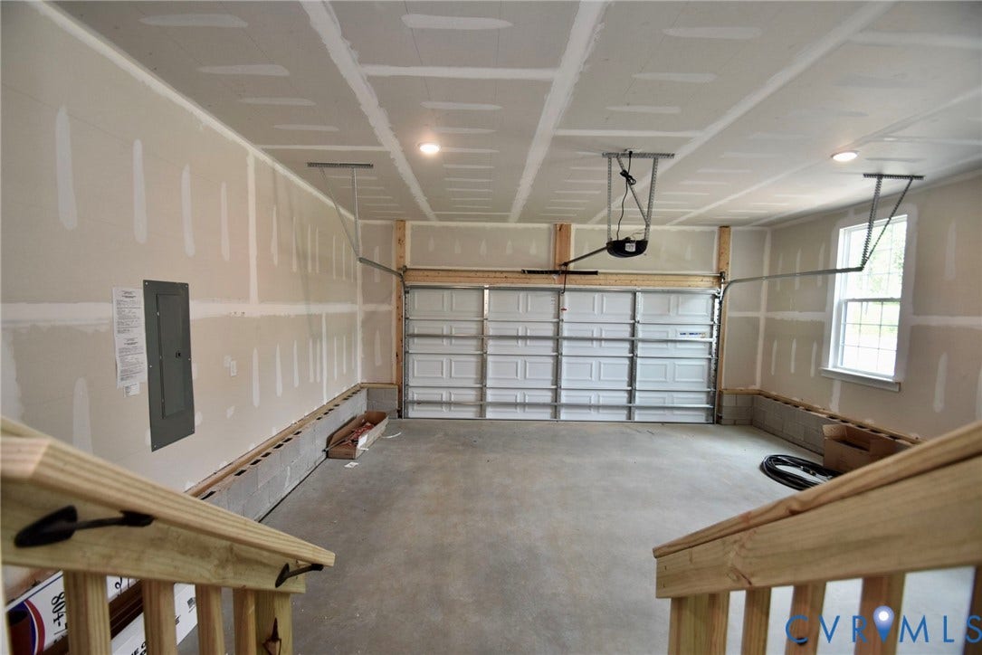 53 Porkchop Court, Louisa, VA 23093 Garage space featuring a concrete floor, single window, and a garage door with opener