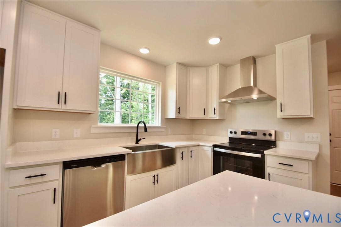 53 Porkchop Court, Louisa, VA 23093 White cabinetry with matte black hardware, stainless steel appliances, stainless steel farmhouse sink, white countertops, and recessed lighting