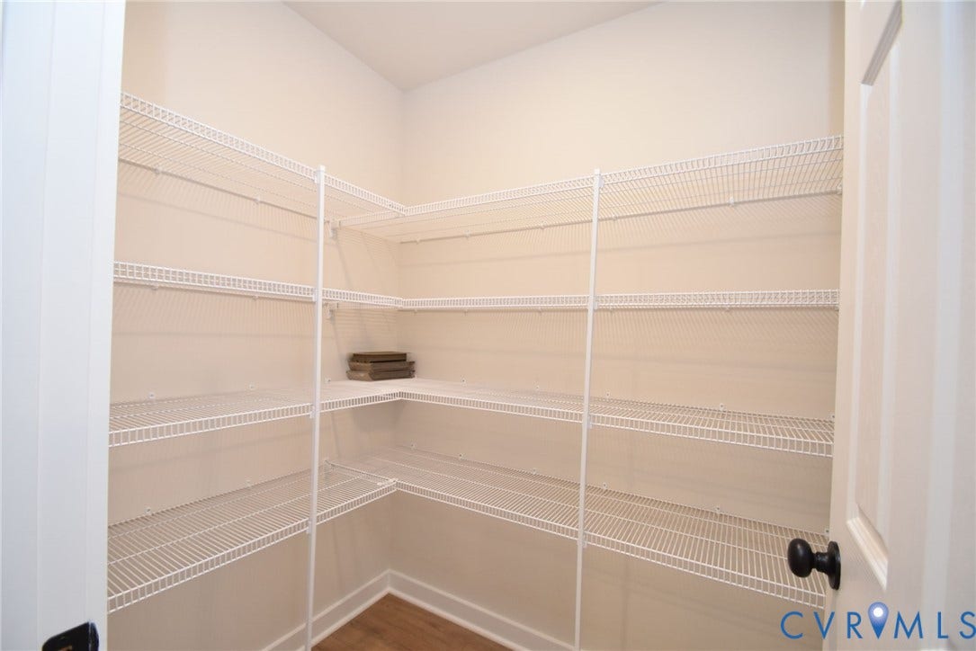 53 Porkchop Court, Louisa, VA 23093 Expansive pantry with multi-level wire shelving, L-shaped shelving configuration, and wood-finish flooring