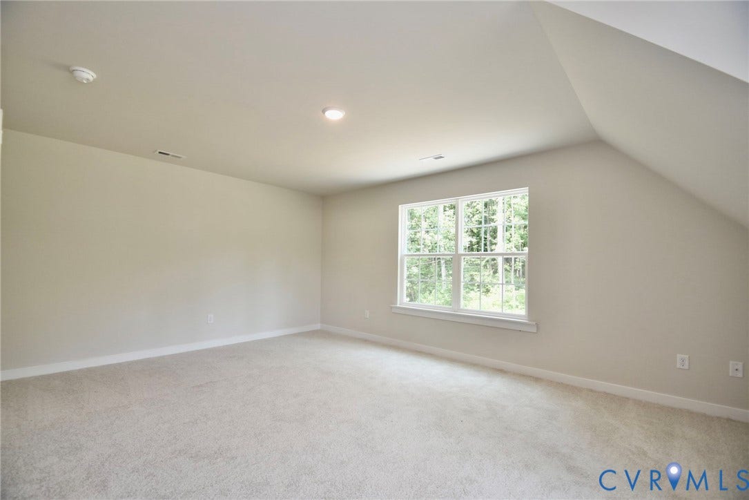 53 Porkchop Court, Louisa, VA 23093 Carpeted room featuring a window with exterior scenery, sloped ceiling, and recessed lighting