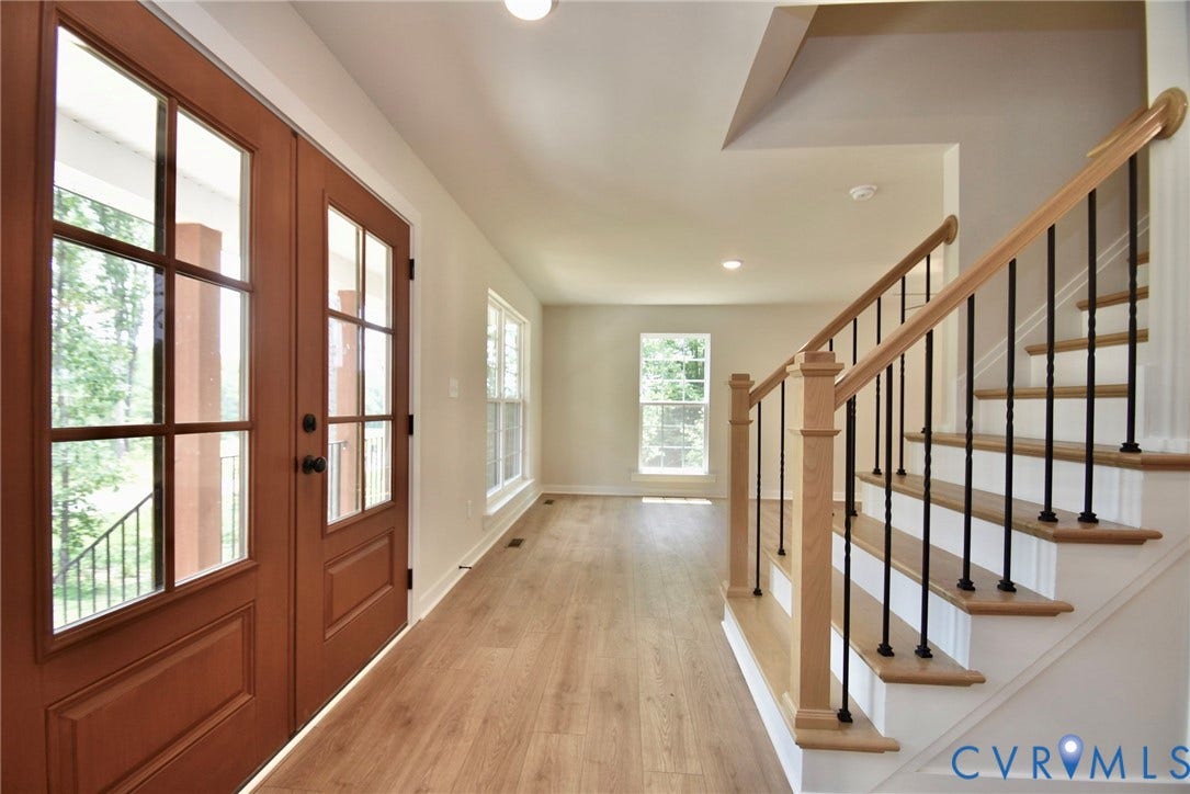 53 Porkchop Court, Louisa, VA 23093 Double entry doors with glass panels, wood-finish flooring, staircase with wood handrail and black balusters, recessed lighting, and multiple windows
