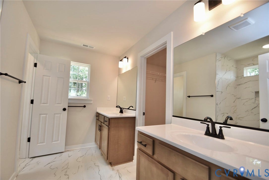 53 Porkchop Court, Louisa, VA 23093 Dual vanities with white countertops, undermount sinks, and matte black fixtures