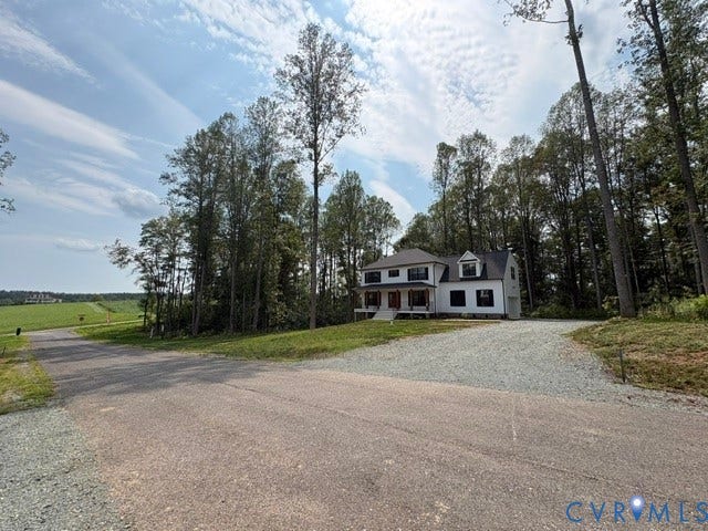 53 Porkchop Court, Louisa, VA 23093 Classic Colonial residence set on expansive grounds with mature tree-lined perimeter, circular gravel driveway, and open pastoral vistas