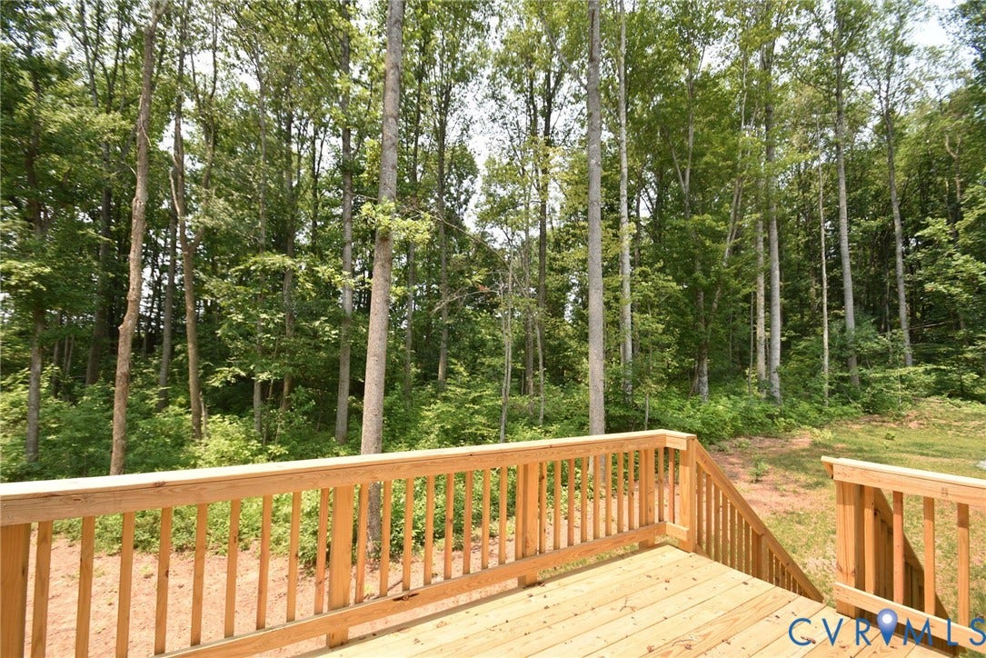 53 Porkchop Court, Louisa, VA 23093 Wood deck with natural wood railing, surrounded by mature trees