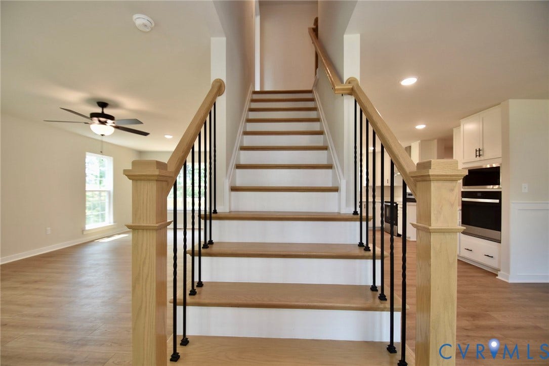 53 Porkchop Court, Louisa, VA 23093 Staircase featuring wood-finish treads and handrail with black iron balusters