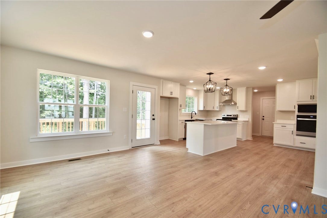 53 Porkchop Court, Louisa, VA 23093 Open-concept living space featuring wood-finish flooring, recessed lighting, a kitchen island, and stainless steel appliances