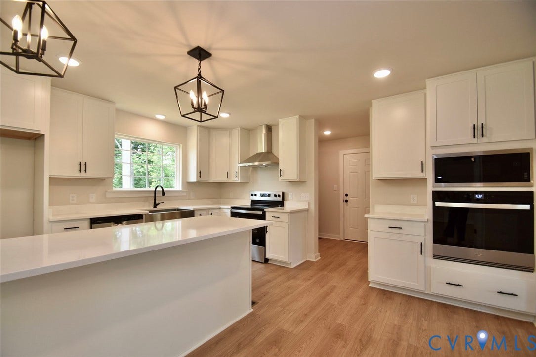 53 Porkchop Court, Louisa, VA 23093 Kitchen featuring white cabinetry, light-toned countertops, wood-finish flooring, recessed lighting, and stainless steel appliances