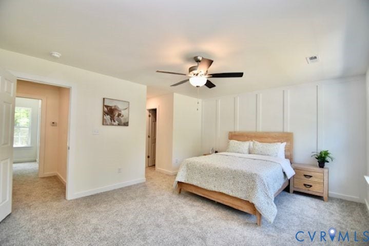 54 Porkchop Court, Louisa, VA 23093 Carpeted room with a ceiling fan, accent wall paneling, and an interior doorway