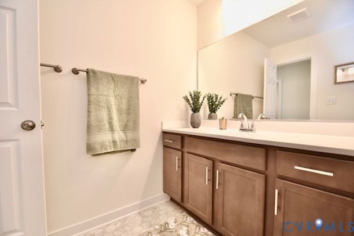 54 Porkchop Court, Louisa, VA 23093 Extended vanity with light-toned countertop, integrated sink, and brushed nickel faucet