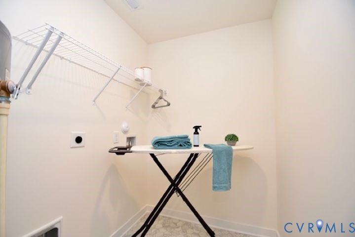 54 Porkchop Court, Louisa, VA 23093 Wall-mounted wire shelving with hanging rod, durable flooring, and neutral wall tones