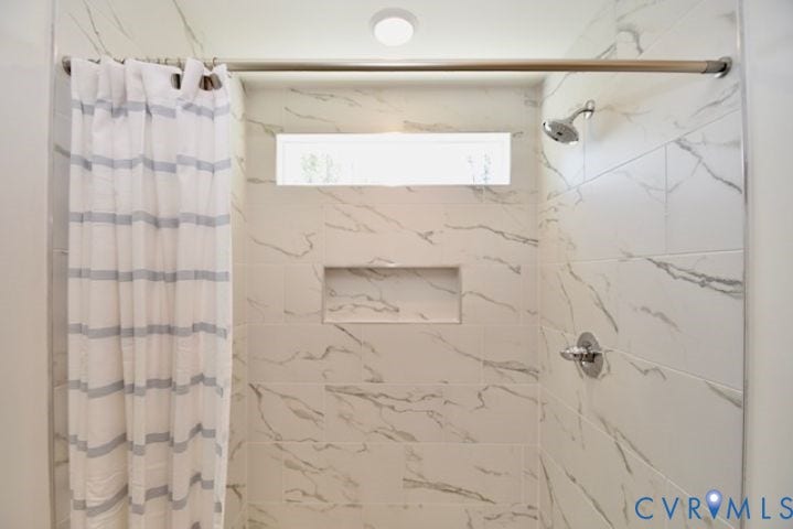 54 Porkchop Court, Louisa, VA 23093 Shower with large format marble-look tile, built-in niche, and transom window