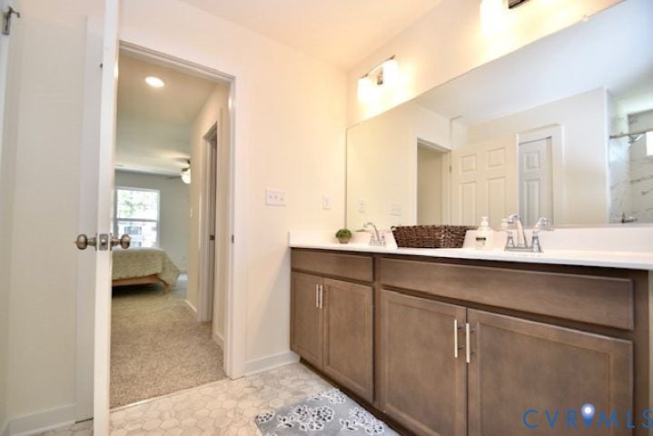 54 Porkchop Court, Louisa, VA 23093 Dual vanity with undermount sinks, wood-finish cabinetry, and a large wall-mounted mirror