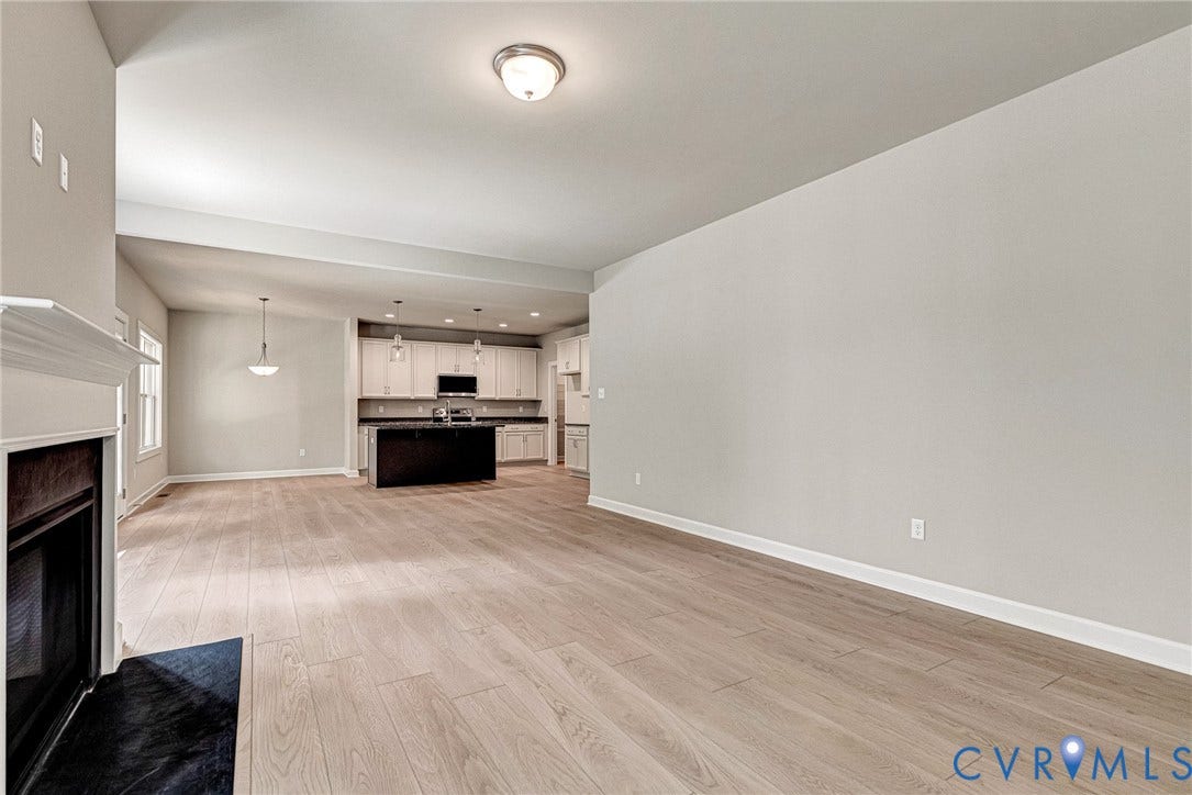 Kitchen with white cabinetry, stainless steel appliances, and a central island with a granite-style countertop